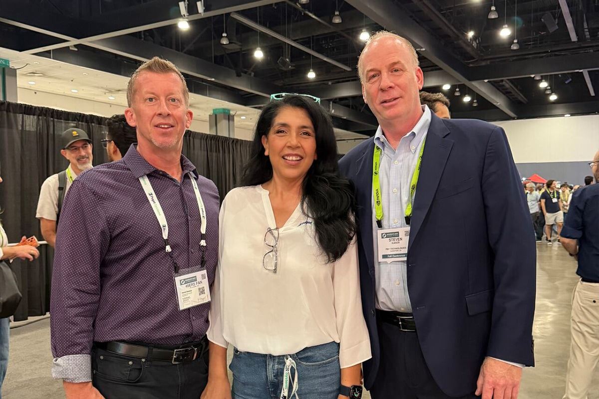 Technology industry professionals attending a conference and networking on the show floor