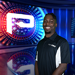 Headshot Jerome Nelson wearing a black and white branded PNYPRO button up polo shirt smiling